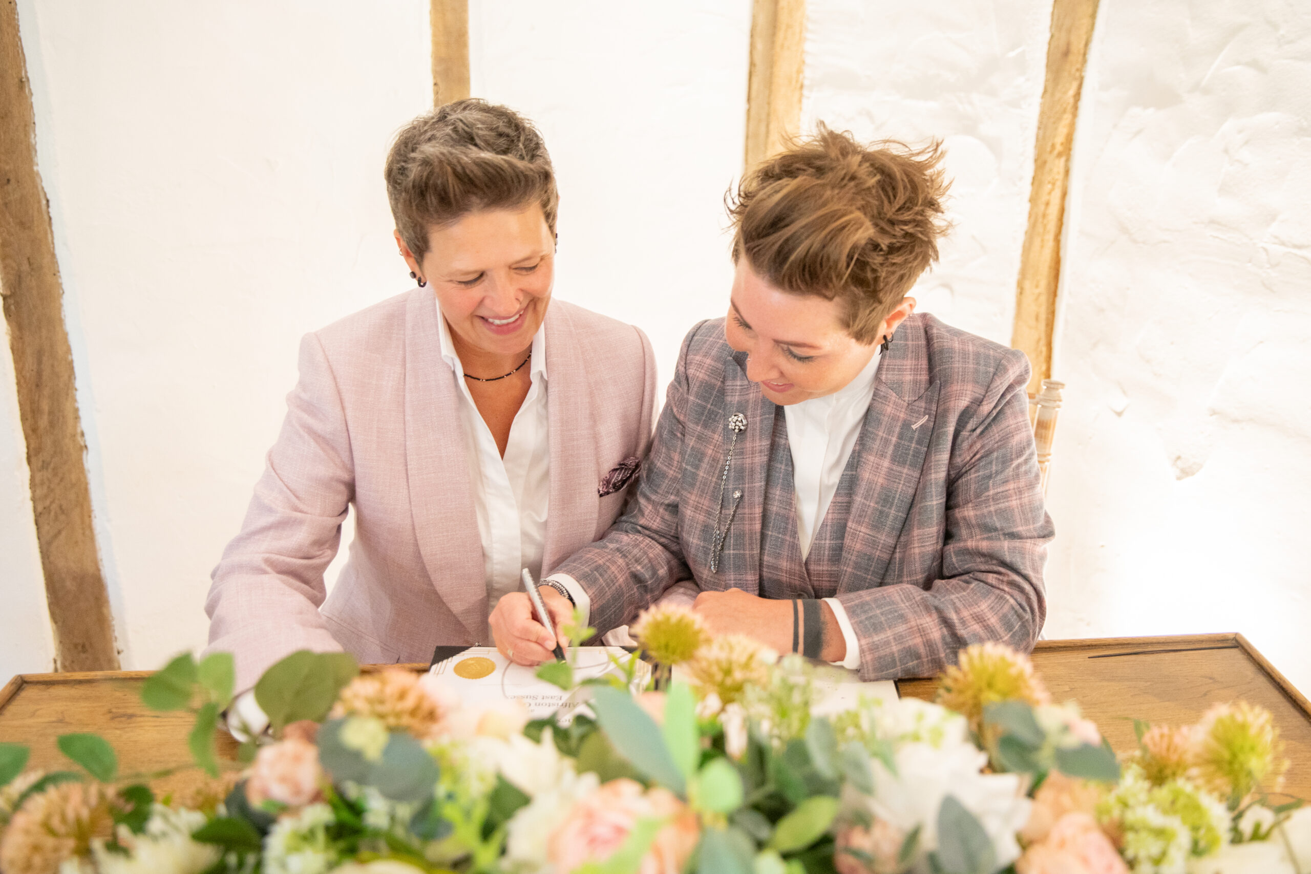Wedding couple signing during wedding ceremony