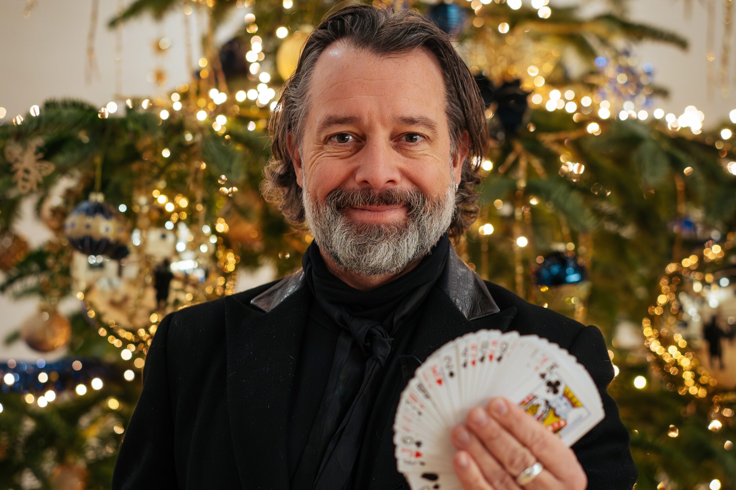 Magician next to Christmas tree