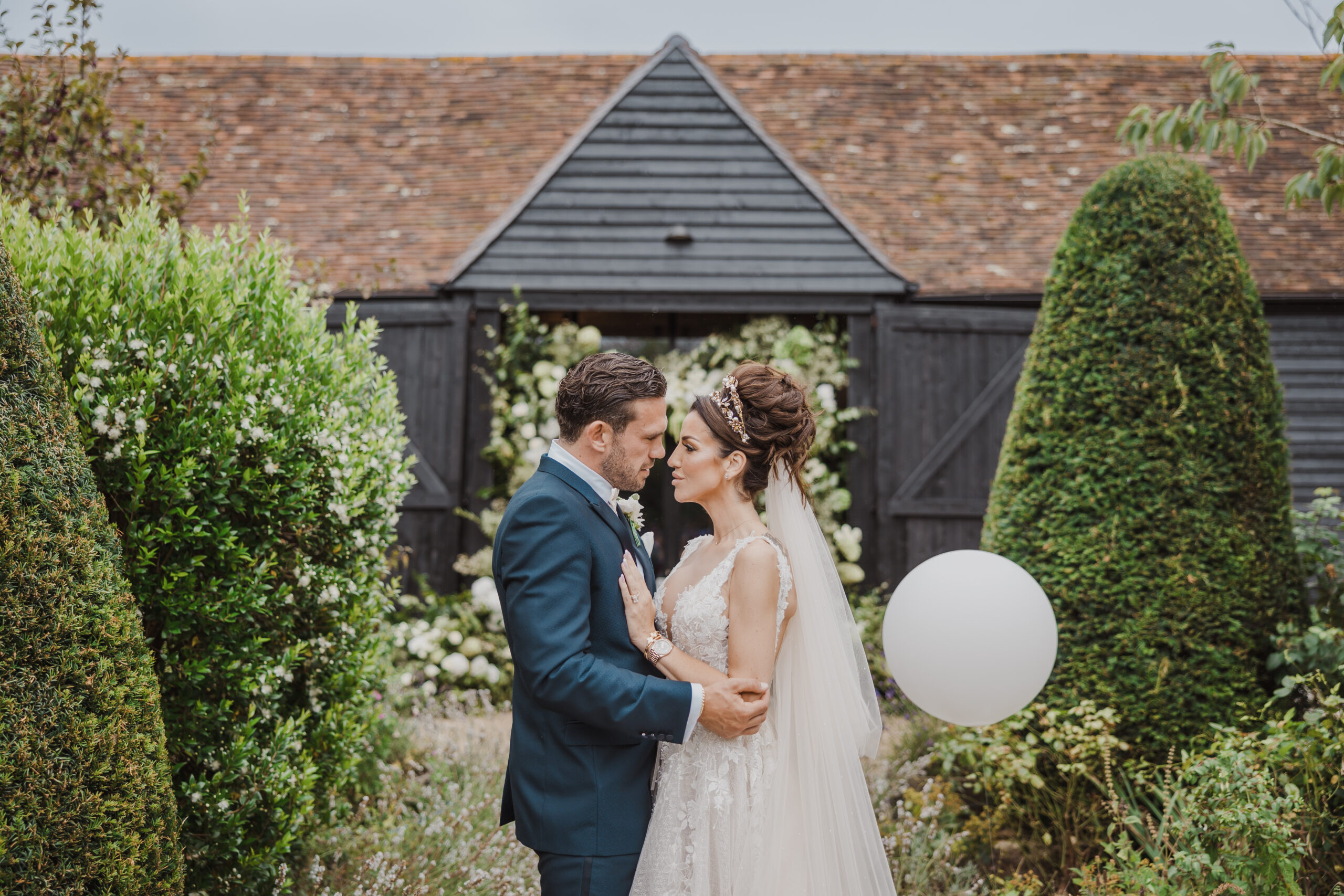 Century barn exterior with wedding couple