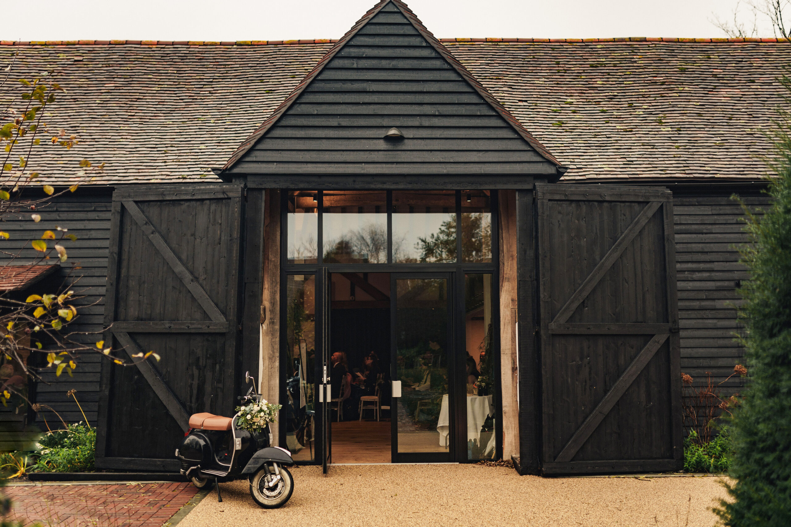 Exterior of wedding barn with motorcycle out the front