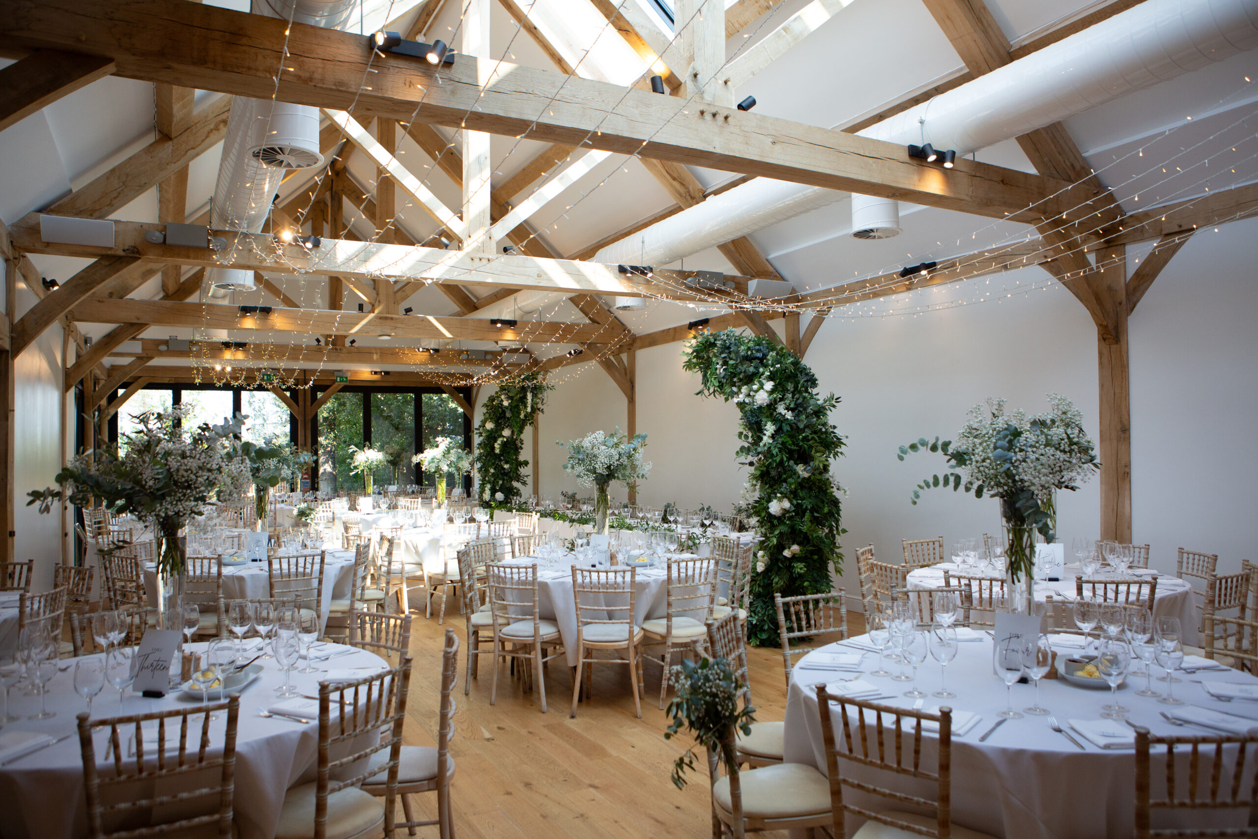 Wedding reception setting inside the Woodland Barn at Alfriston Gardens