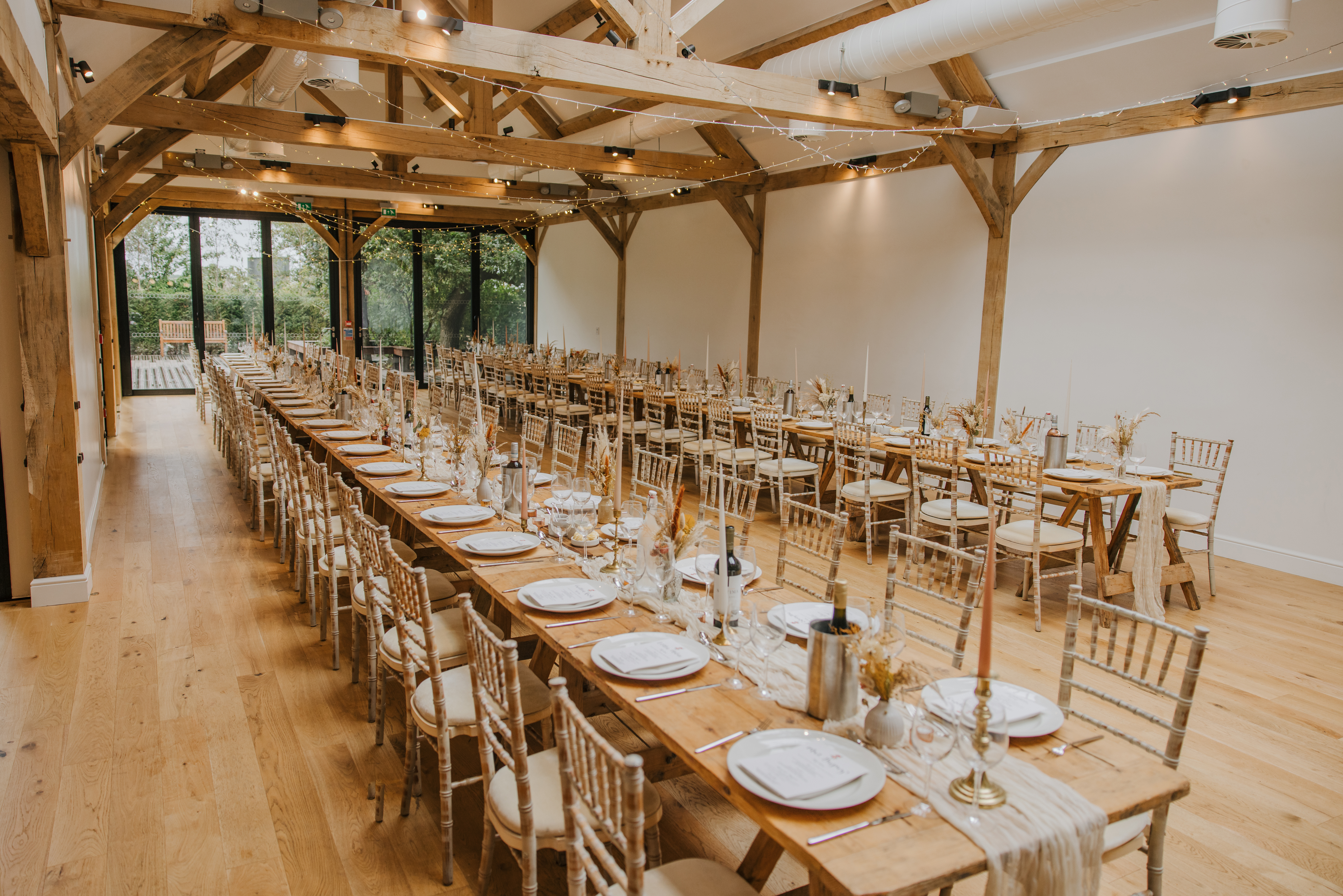 Wedding barn set for a meal with tressel tables